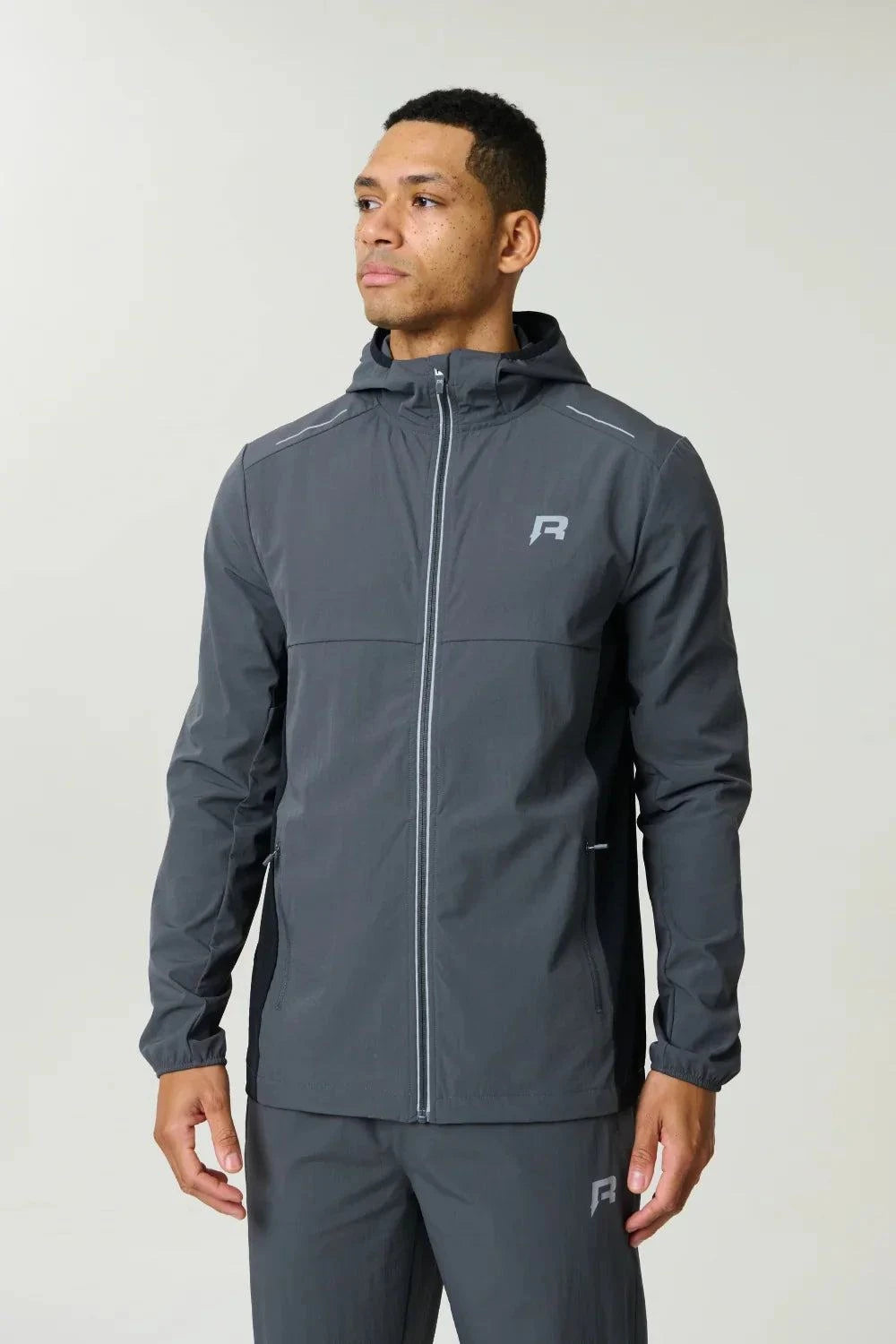 Reprimo Clima Shell Jacket in slate and obsidian, insulated and lightweight with reflective branding and secure zip pockets.