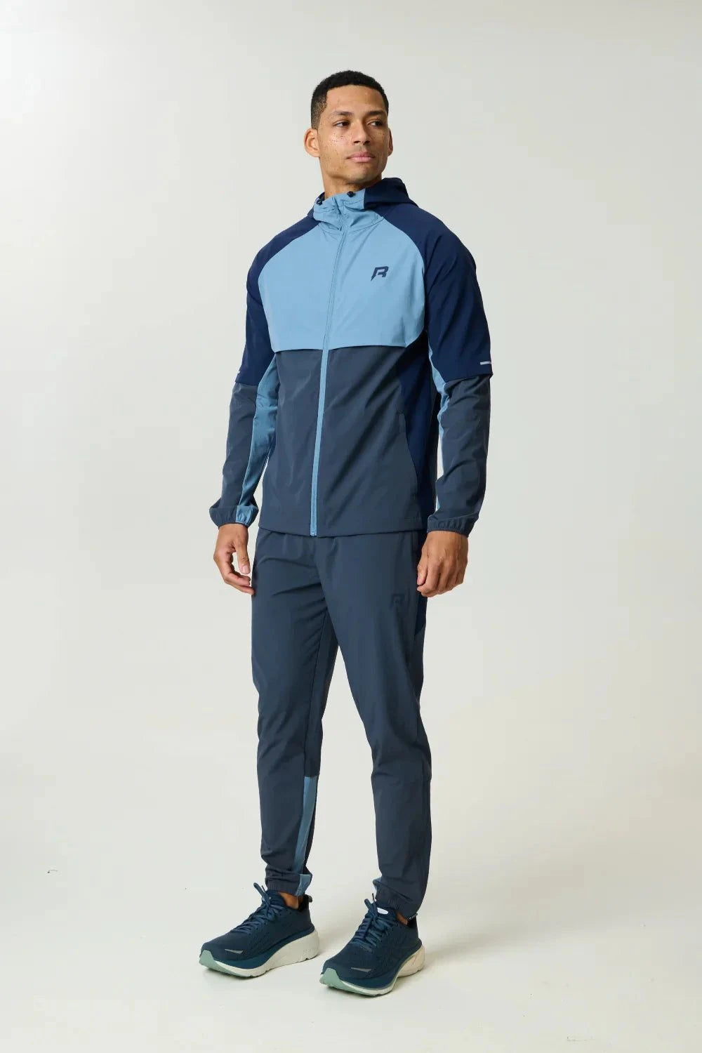 Reprimo Vortex Windbreaker in dusty blue and ink blue with ergonomic design and reflective details