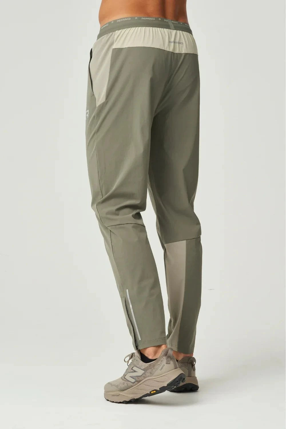Khaki Reprimo Flight Pant with functional pockets and reflective strips for athletic performance and comfort