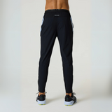 Rear view of a person wearing black Reprimo Flight Pants with dusky sky accents, featuring reflective strips and a comfortable, sporty fit.