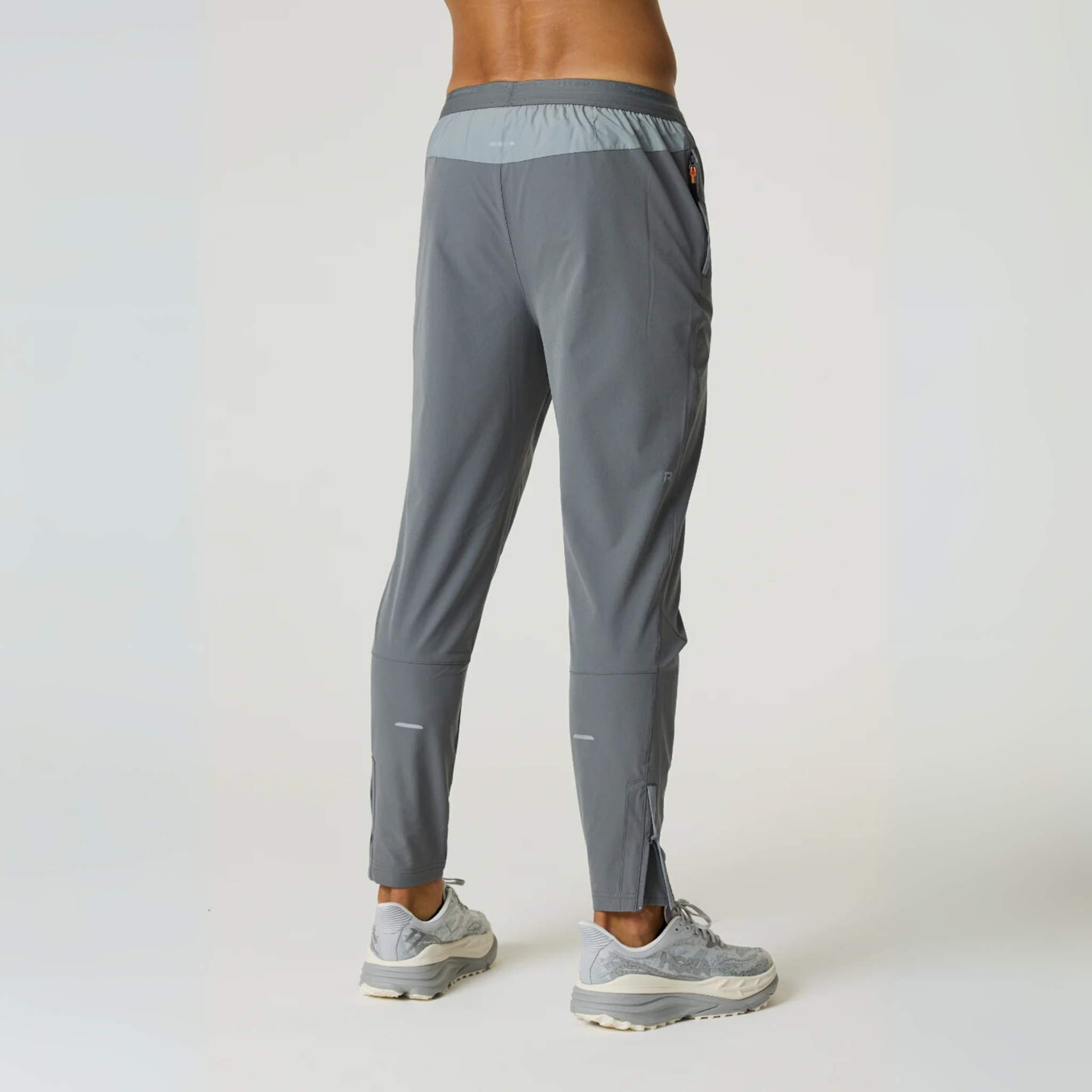 Reprimo Summit Pant in slate and light grey with custom jacquard waistband and lockable zip puller, modeled from the back.