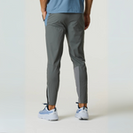 Back view of a person wearing Reprimo Flight Pants in Air Force Blue and Gunmetal with reflective strips, designed for performance and comfort.