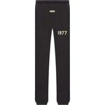 Fear of God Essentials black sweatpants with elastic cuffs and 1977 print