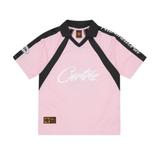 Pink Corteiz Script paneled jersey with black collar and sleeve accents