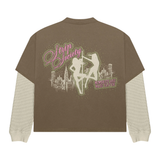 Strip Society T-Shirt with layered brown short sleeve, built-in textured long sleeves, pink graphic skyline and "Memories Are Made Faster" text