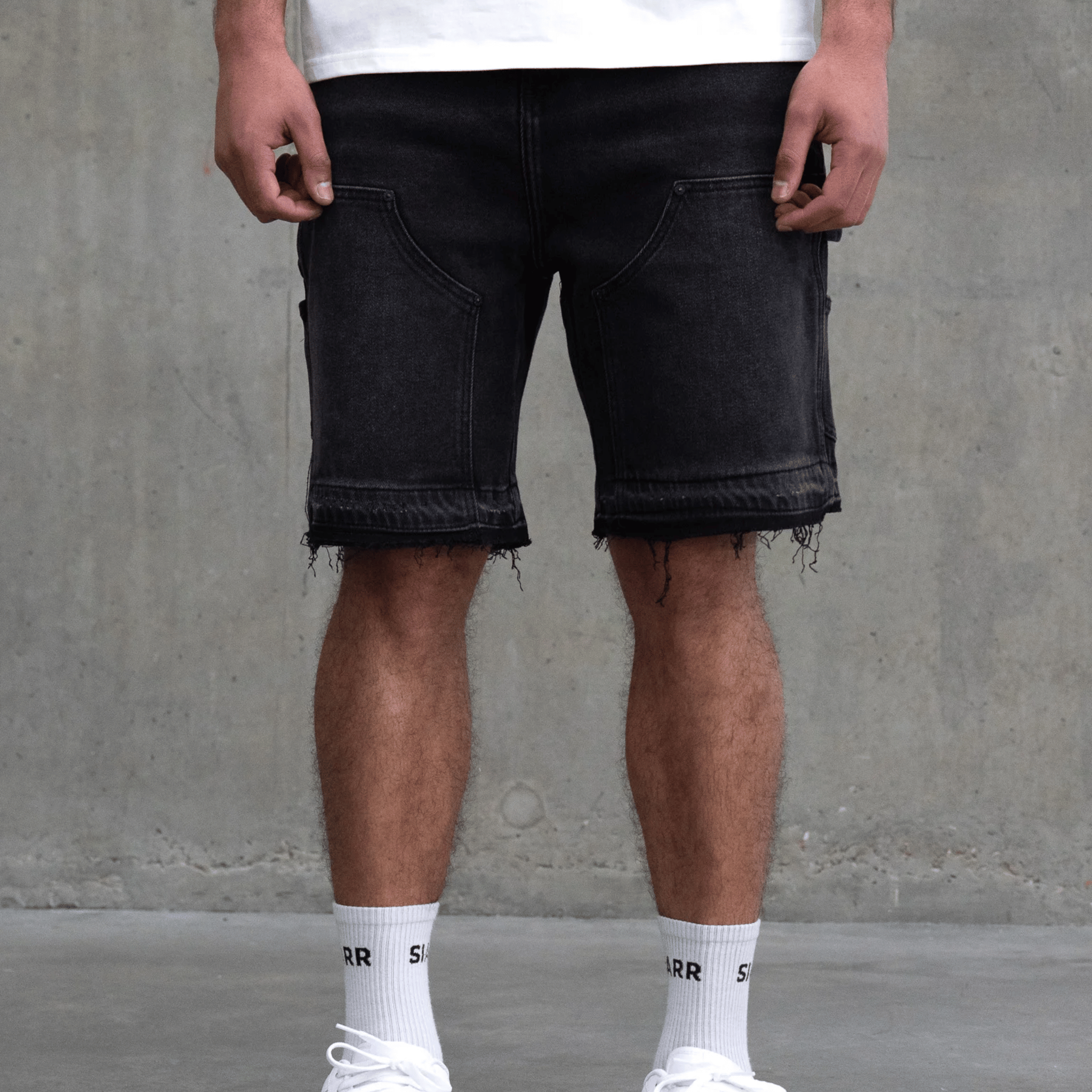 Siarr Carpenter Shorts Black with carpenter style pockets and distressed hem.