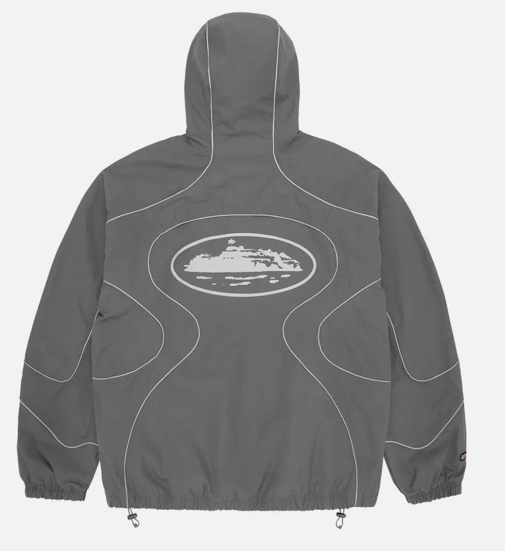 Corteiz x Nike NRG Jacket in Gully Grey with hood and abstract back design.