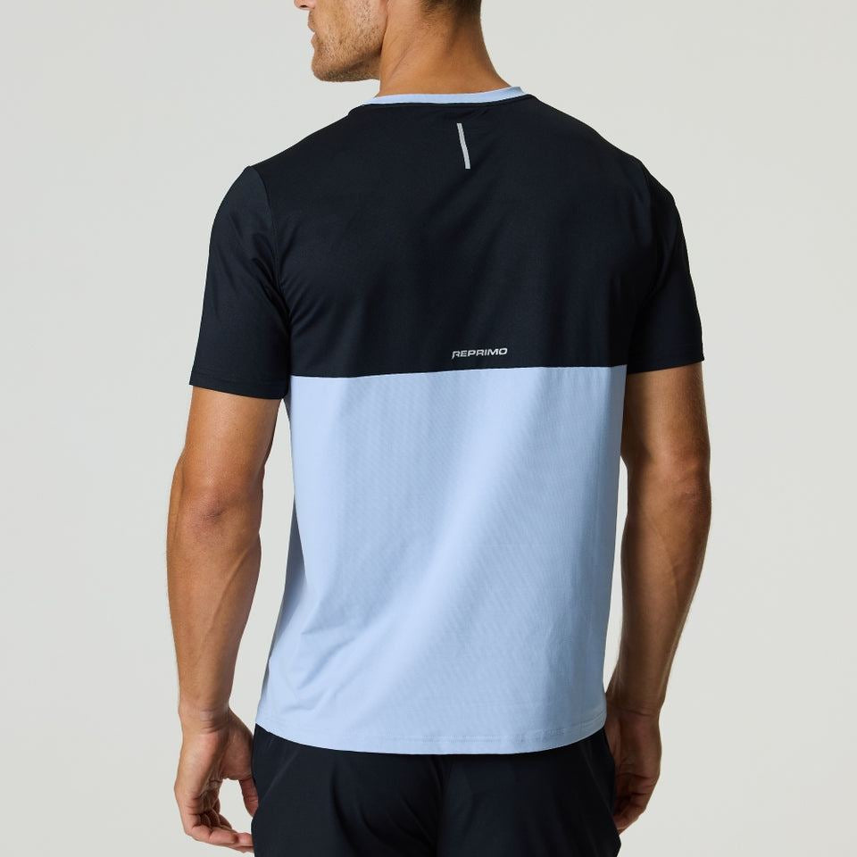 Back view of man wearing black and dusky sky Reprimo Flight T-Shirt with reflective strip and two-color block design
