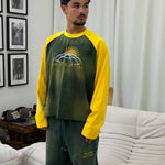 Saint Hills College long sleeve green raglan shirt with yellow sleeves and globe sun graphic