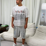 White Suavo World Valley Hills T-Shirt with distressed finish and multicolored checkerboard graphic