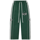 Vale Forever green stripe trackpants laid flat on white background
