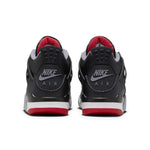 Air Jordan 4 Retro Bred Reimagined GS sneakers, rear view showing black and red colorway.