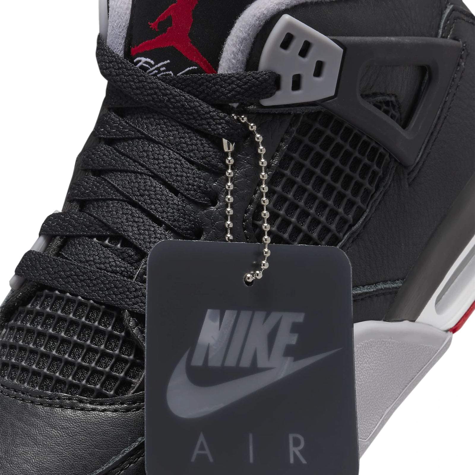 Air Jordan 4 Retro Bred Reimagined GS leather mesh upper with black and red tones.