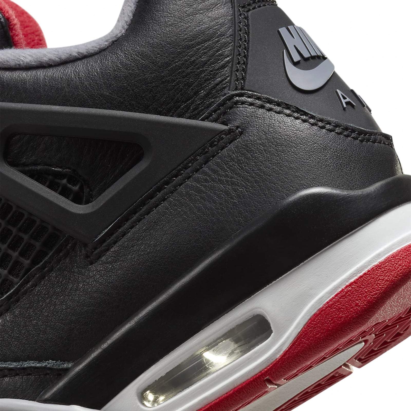 Air Jordan 4 Retro Bred Reimagined GS sneaker detail in black, grey, and red with Air cushioning.