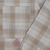 Close-up of Cherry Location Beige Shirt showing beige plaid fabric with blue and brown lines and a pink cherry logo on the pocket