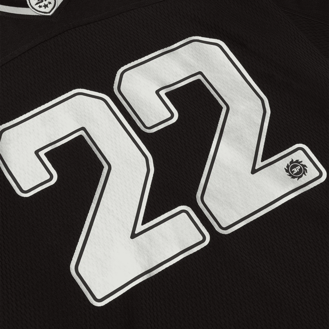 Broken Planet Market black silver football jersey with number 22.