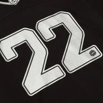 Broken Planet Market black silver football jersey with number 22.