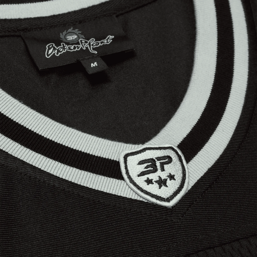 Broken Planet Market Football Jersey in black and silver with embroidered logos.