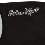 Black and silver Broken Planet Market football jersey close-up.