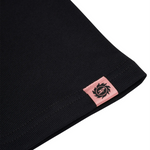 Black t-shirt with Broken Planet logo tag on hem.
