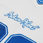 Broken Planet Market Football Jersey in White and Blue with logo detailing.