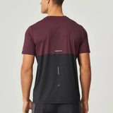 Back view of man wearing burgundy and obsidian Reprimo Impact T-Shirt with ergonomic fit and color pop accents