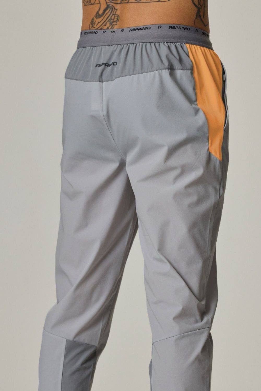 Reprimo Flight Pants in grey with orange accents.
