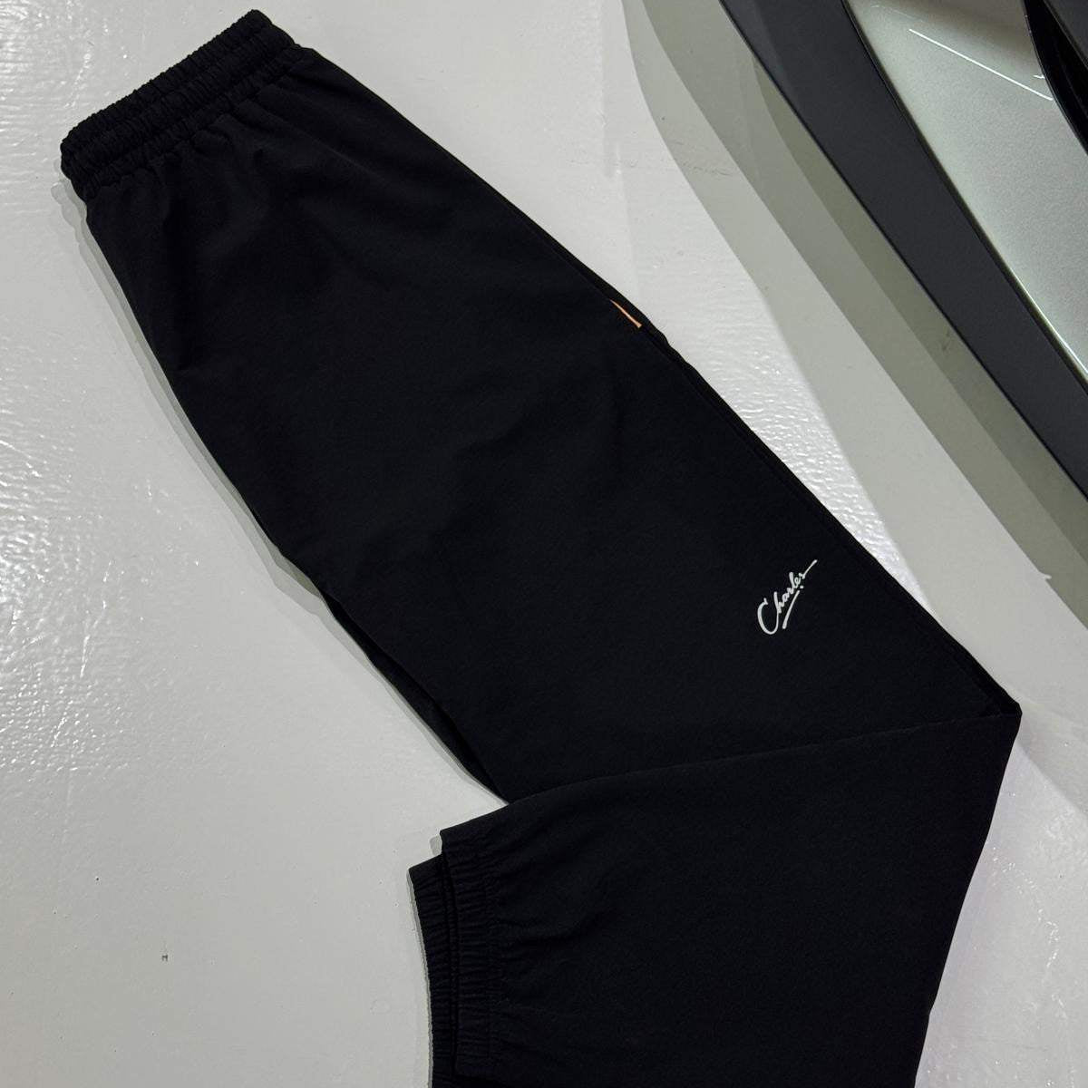 Studio By Charles black trackpants with elastic cuffs and logo embroidery