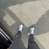 Studio By Charles charcoal grey trackpants worn with white sneakers on pavement background