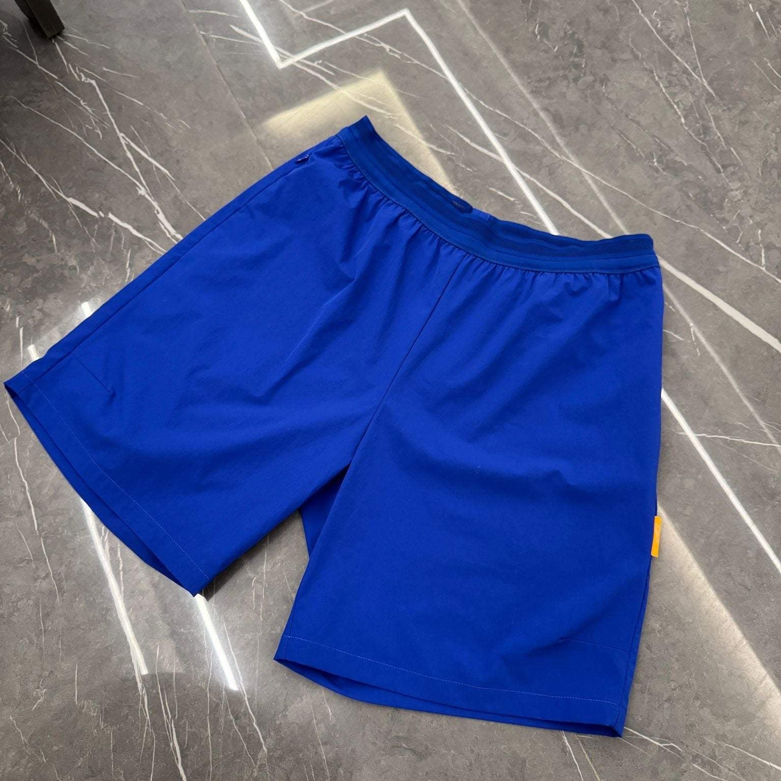 Studio By Charles royal blue studio shorts with elastic waistband on gray marble floor