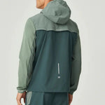 Reprimo Flight Windbreaker in hunter green and botanical colors with hood, zip pockets, and back vent for ventilation, designed for lightweight weather protection.