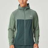 Man wearing hunter green Reprimo Flight Windbreaker with hood and zip pockets