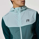 Reprimo Flight Windbreaker in forest green and mint worn by a model.