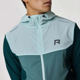 Reprimo Flight Windbreaker in forest green and mint worn by a model.