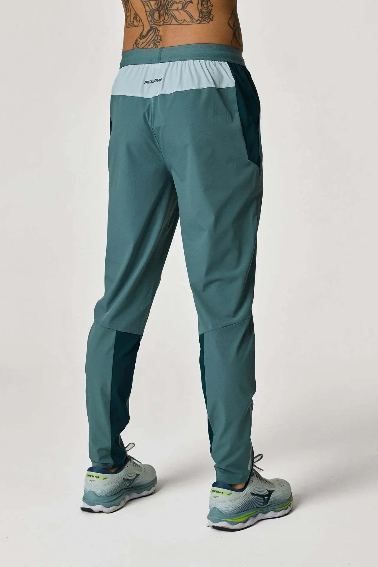 Reprimo Flight Pants in Forest Green and Mint worn from the back.