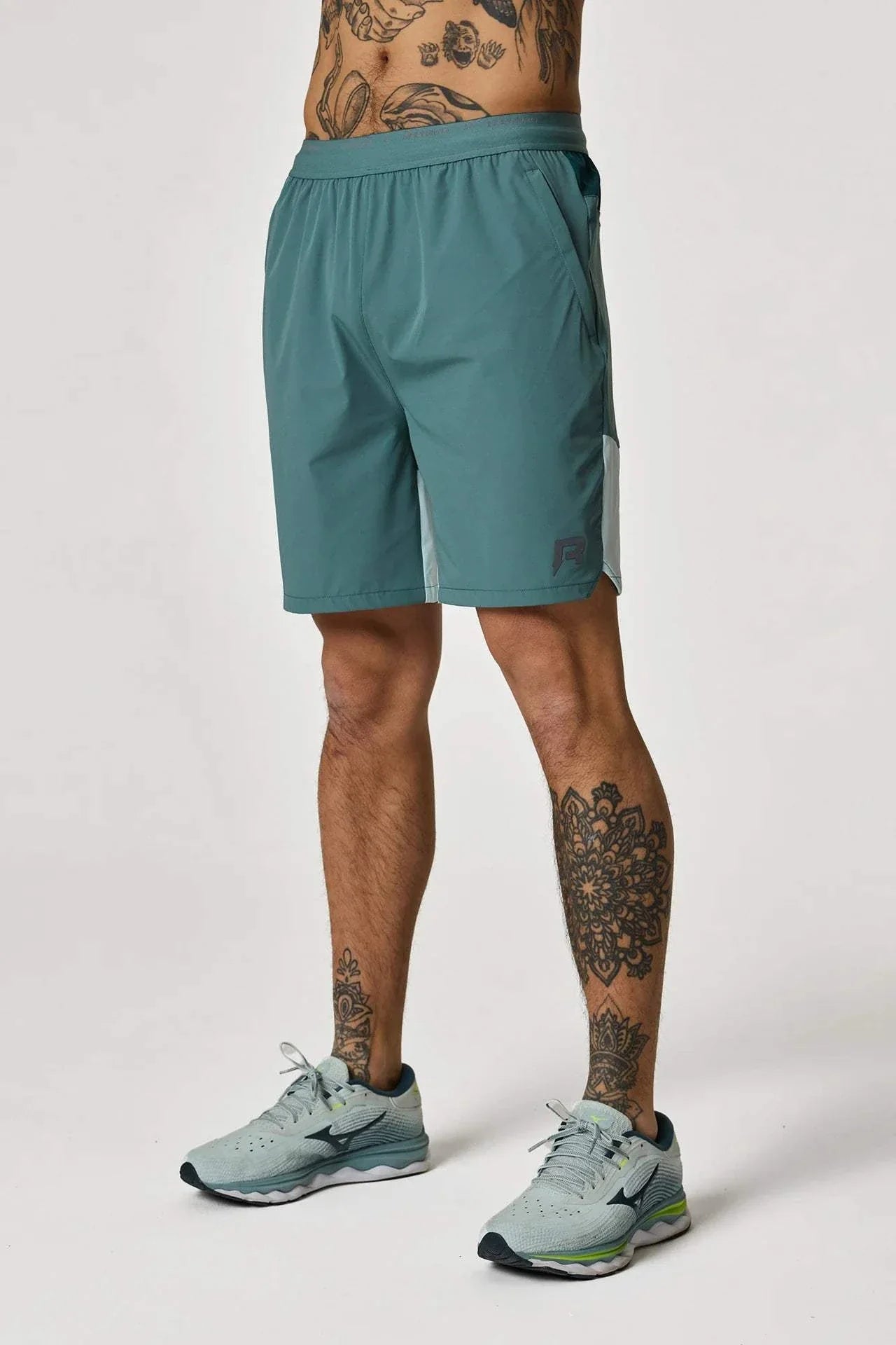 Reprimo Flight Shorts in Forest Green/Mint worn by tattooed model.