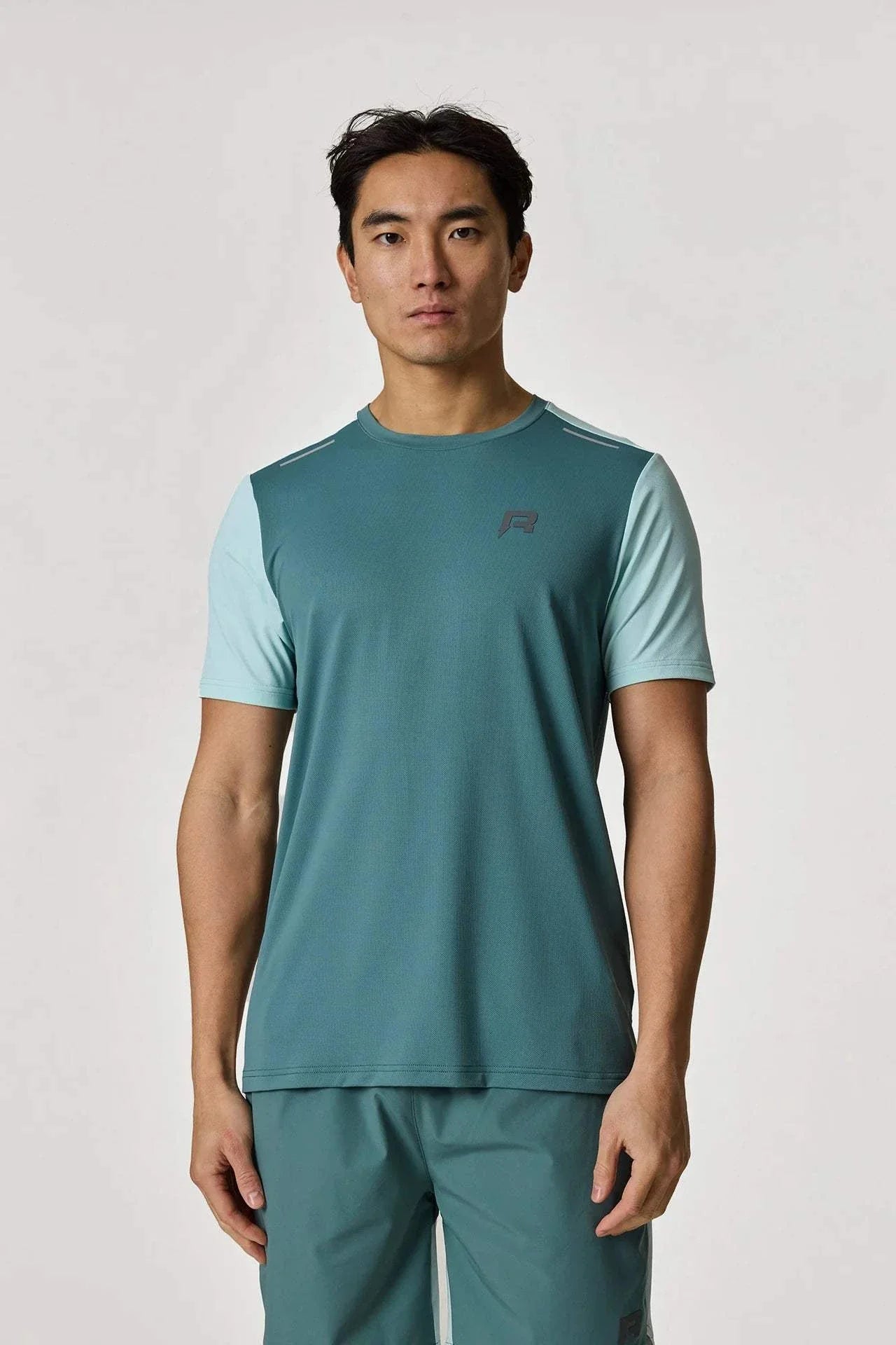 Reprimo Flight T-Shirt in Forest Green and Mint color worn by model.