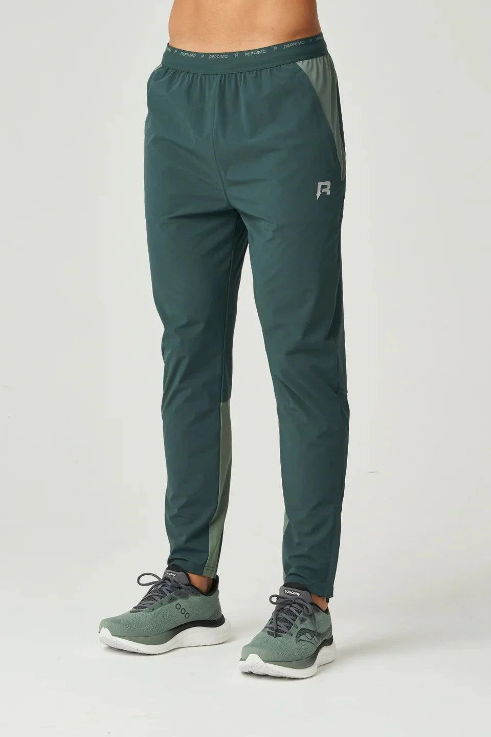 Reprimo Flight Pants in hunter green with reflective strips and secure pockets for athletic performance and comfort