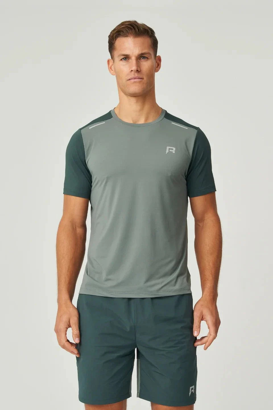 Reprimo Flight T-Shirt in hunter green with botanical accents, lightweight breathable athletic fit for high-intensity workouts, featuring reflective strips for visibility.