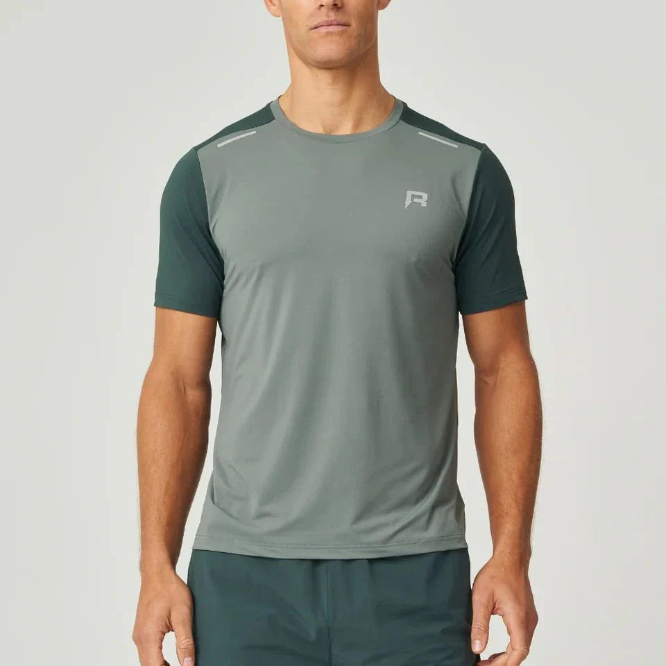 Reprimo Flight T-Shirt in hunter green with botanical accents, lightweight breathable athletic fit for high-intensity workouts, featuring reflective strips for visibility.