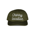 Cherry Location green cap with white embroidered text