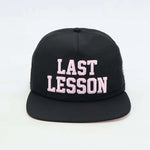 Black Last Lesson SnapBack Hat with bold white lettering.