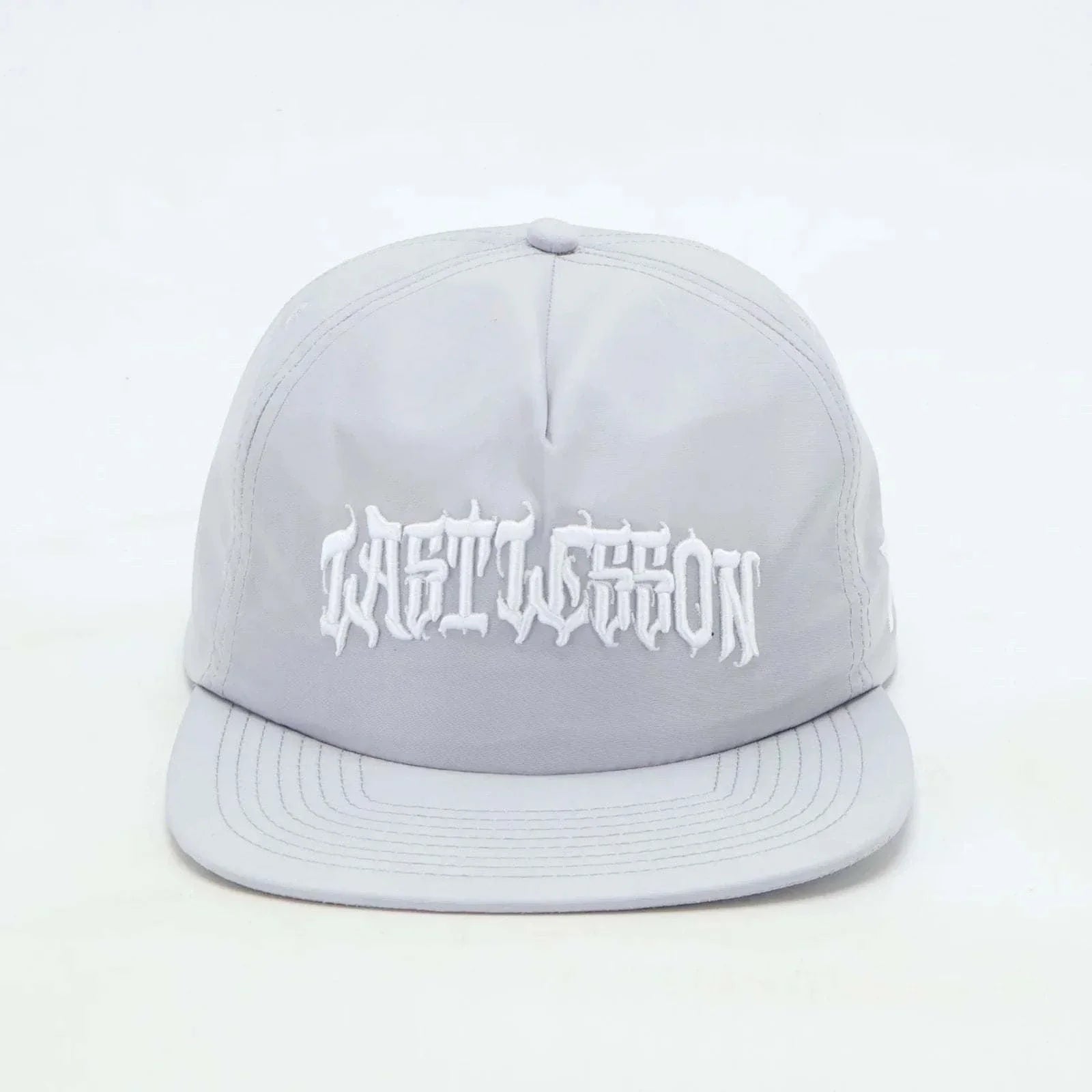 Grey Last Lesson SnapBack Hat with embroidered text.