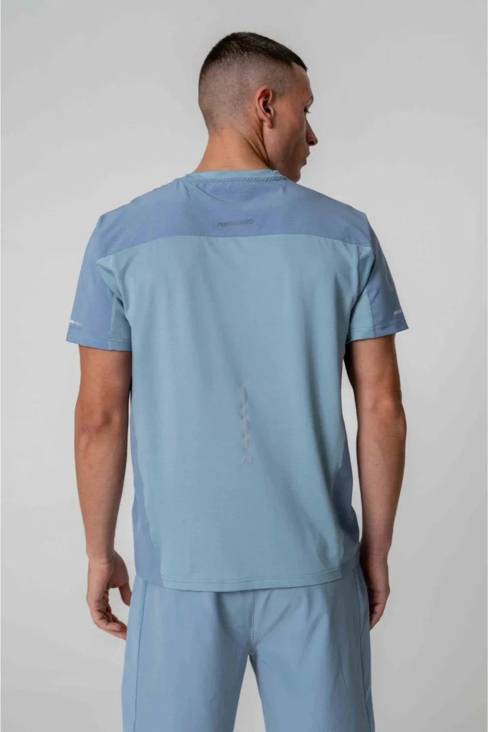 Reprimo Nova T-Shirt in Aqua and Dusk Blue worn by model, back view.