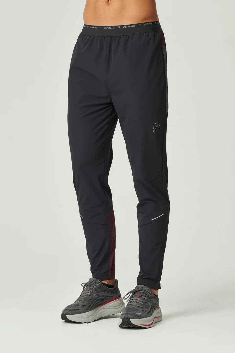 Men's Reprimo Impact Pants in burgundy and obsidian with dual-fabric panelling and ergonomic fit for athletic performance