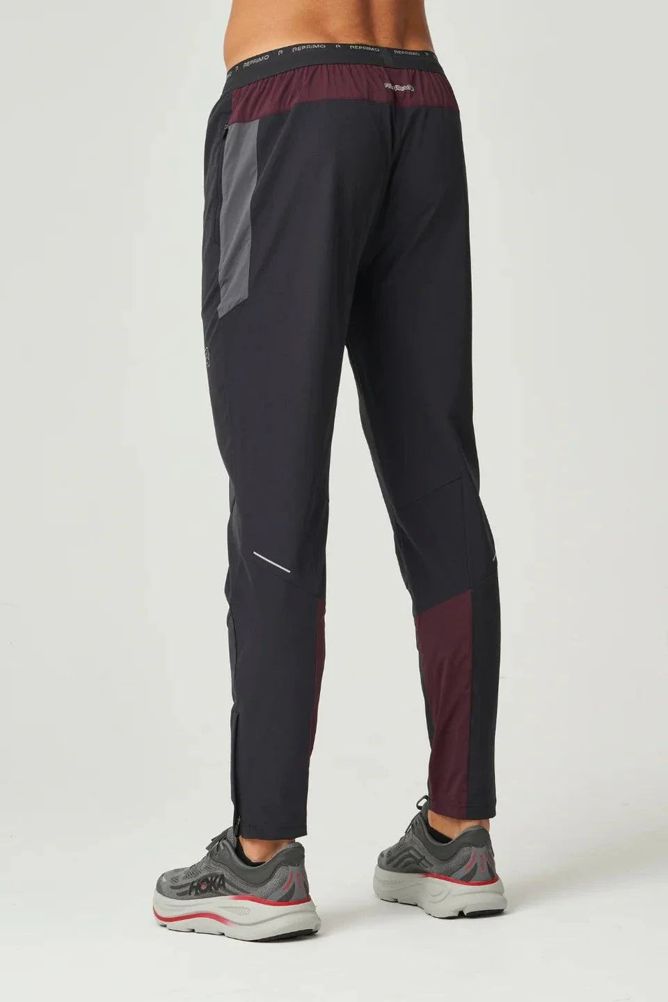 Men wearing burgundy and obsidian Reprimo Impact Pants with dual-fabric paneling and ergonomic fit