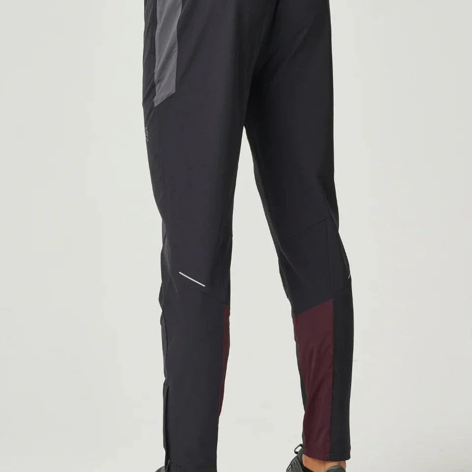 Men wearing burgundy and obsidian Reprimo Impact Pants with dual-fabric paneling and ergonomic fit