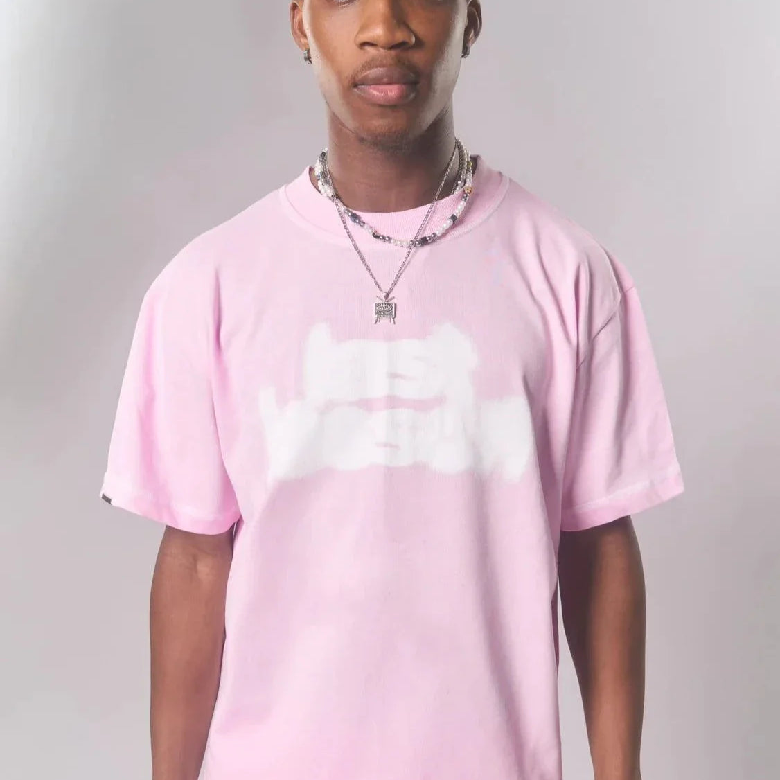 Last Lesson Pink Blurred T-shirt worn by a model.