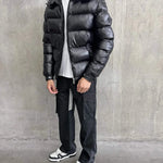 Siarr Lightweight Jacket black puffer jacket with detachable hood and zippered pockets worn by male model