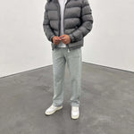 Siarr Lightweight Jacket dark grey padded with detachable hood and zippered pockets on male model